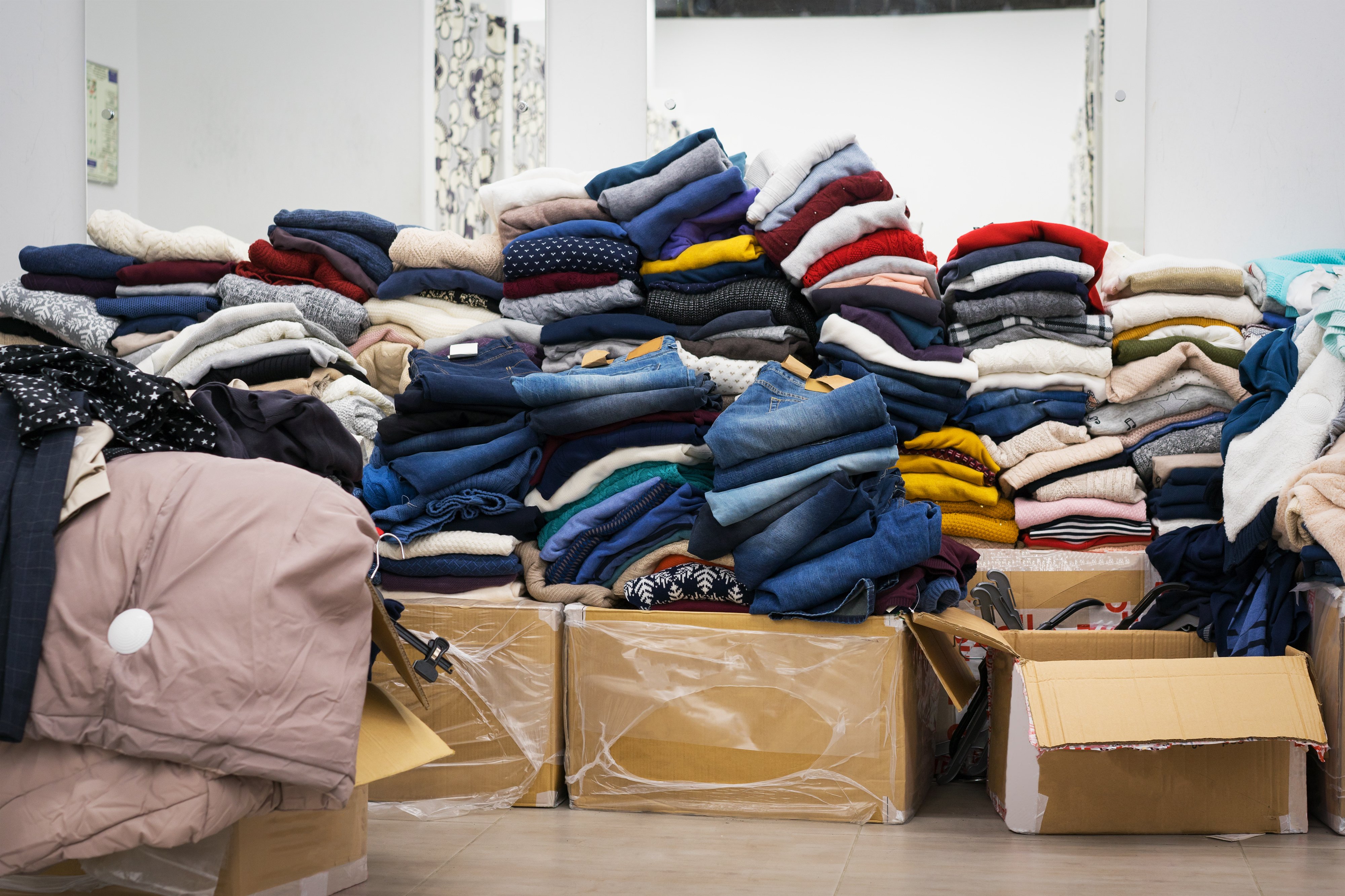 Stock clothing - A collection jeans, sweaters, jackets in modern distribution warehouse in the mall. Inventory, logistic, export concept. Foto: WCRS Ltd.