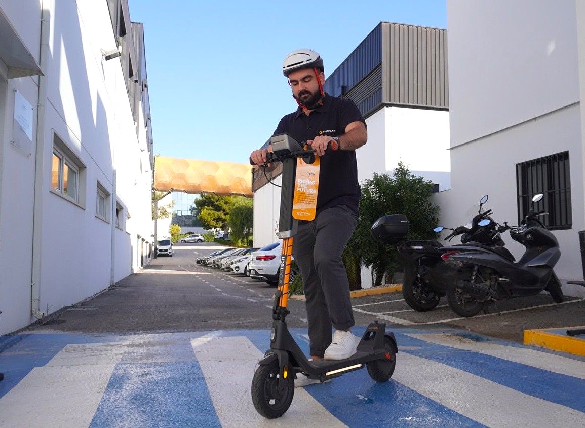 A man rides an electric scooter