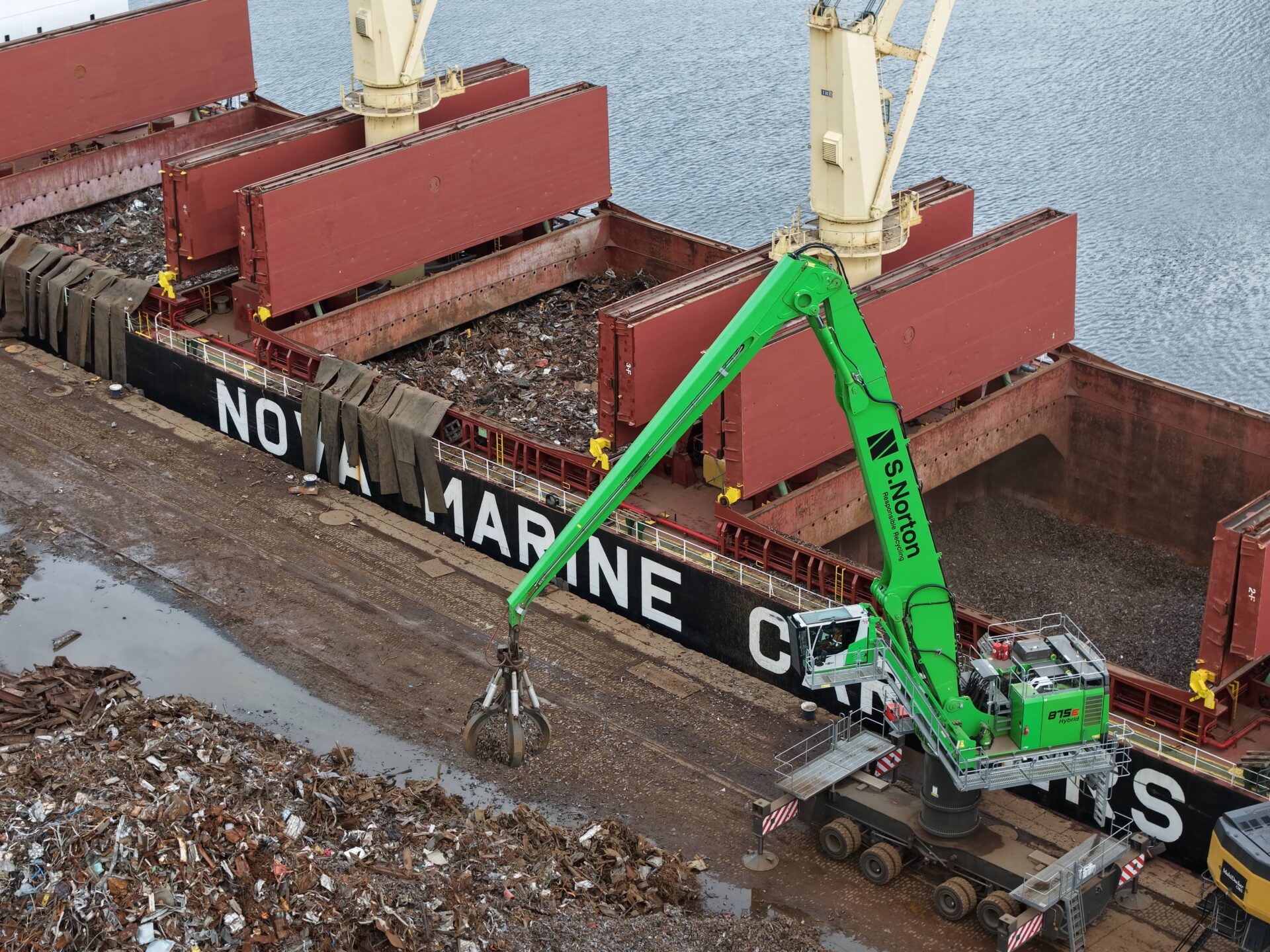 A metal scrap site next to a ship with loaded scrap