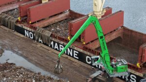 A metal scrap site next to a ship with loaded scrap